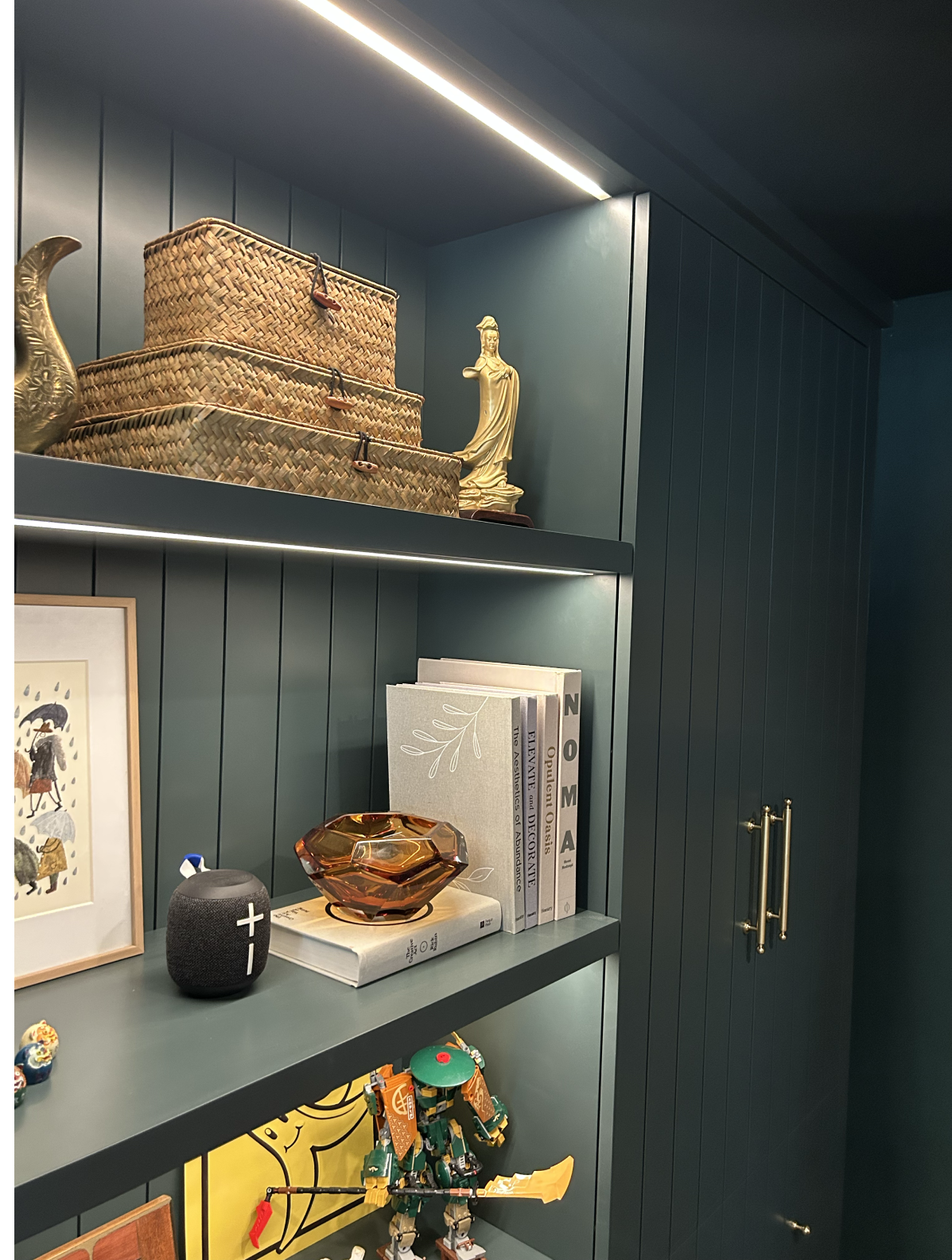 Decorative shelves with baskets, books, and small art pieces in a cozy room corner.